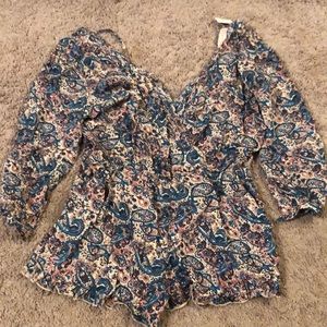 Pink, purple, blue and white patterned romper. Emmeline size M